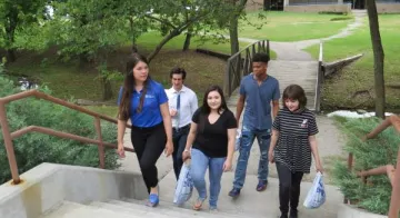 students walking on a path among the trees on TCC Northeast Campus