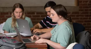 A student looks at a laptop