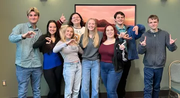 Early College Academy alumni pose for a photo