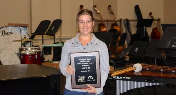 TCC Band Director Cheryl Lee holds up the George N. Parks Leadership in Music Education Award