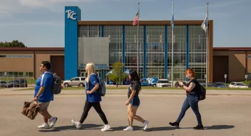 Four students walk in front of the TCC Southeast Student Success Center