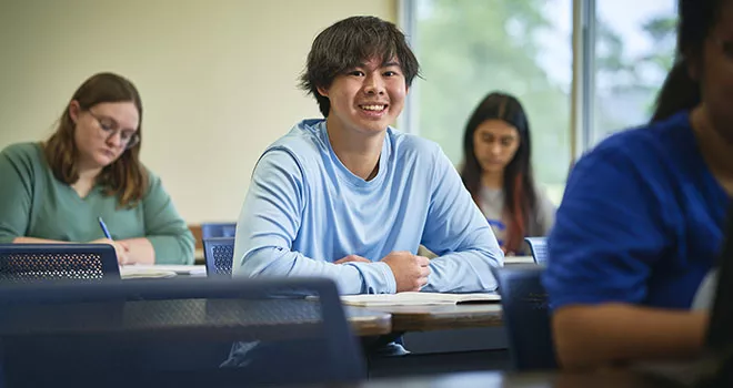 smiling guy in blue long sleeve shirt