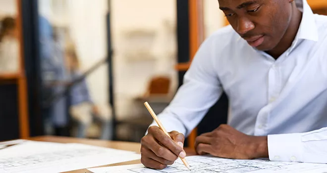 a man drafting on paper