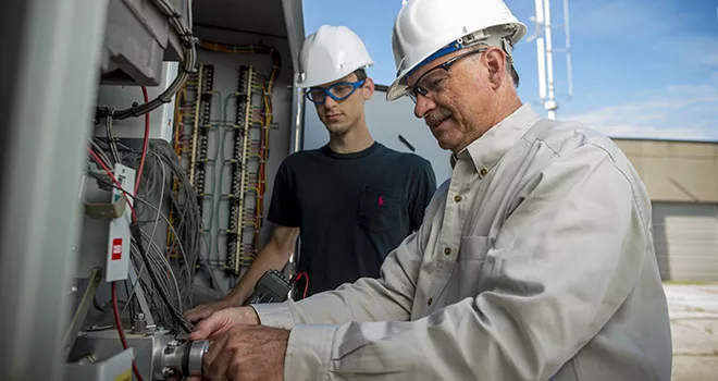 two men working at an electrical box