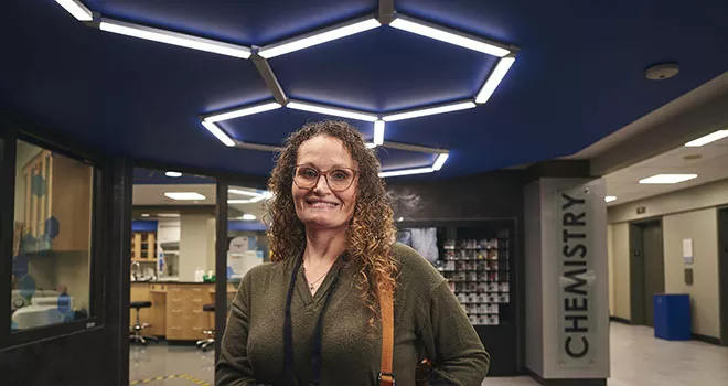 woman smiling outside chemistry lab