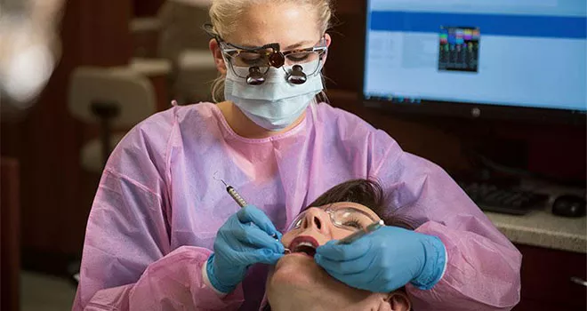 TCC Dental Hygiene Student working on patient