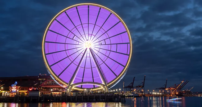 Timelaps photo of a purple lit ferris wheel