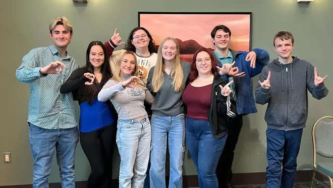 Early College Academy alumni pose for a photo