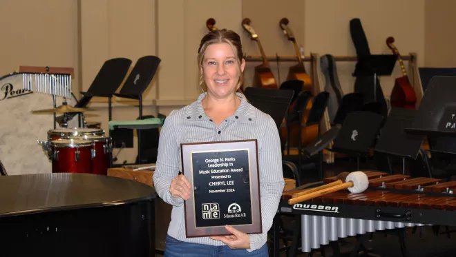 TCC Band Director Cheryl Lee holds up the George N. Parks Leadership in Music Education Award