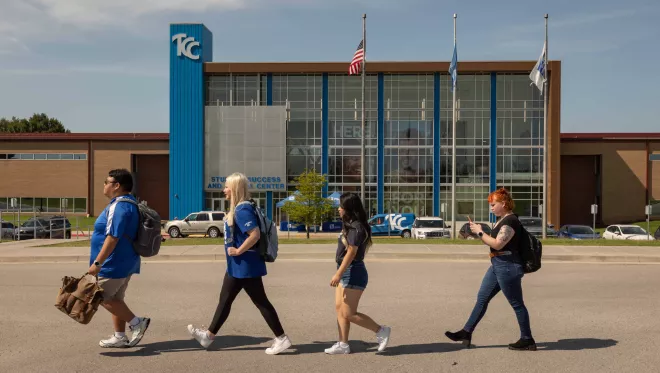 Four students walk in front of the TCC Southeast Student Success Center