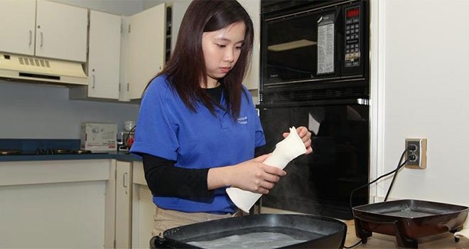 TCC OTA student skillfully molding a cast for forearm/wrist during a hands-on occupational therapy session.