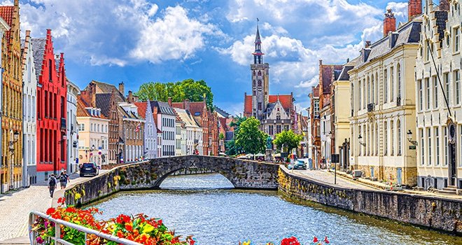 Bruges cityscape, Spiegelrei water canal, Poortersloge tower, King's Bridge and medieval buildings on embankment, Brugge old town quarter,