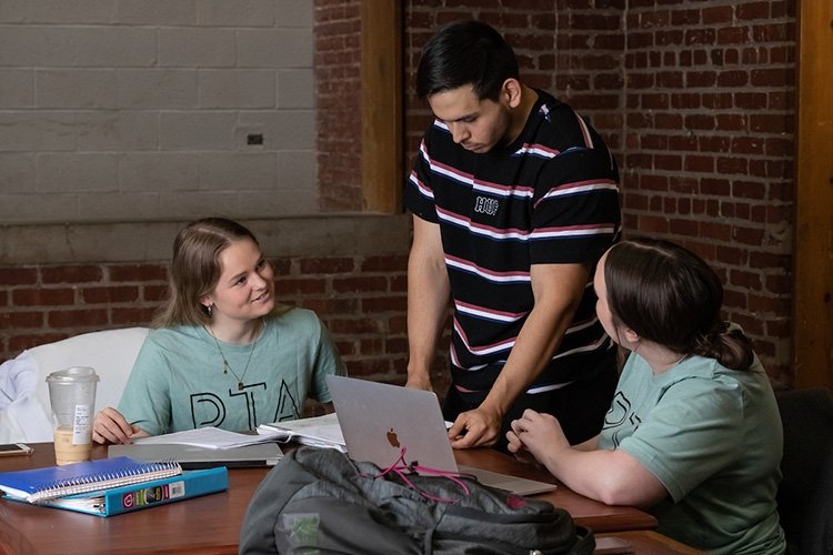 Three students study together at the TCC metro campus.