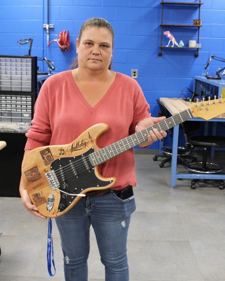 Jennifer Slimp holds her customized guitar